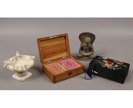 A miniature alabaster font signed Isola Bella, a stone Buddha, Cantonese silk mounted box and a wooden playing card box conta