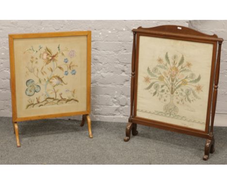 A mahogany firescreen with needlework panel and a similar example folding as an occasional table.