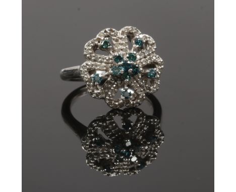 A 10ct white gold floriform ring set with white and blue diamonds, size O.