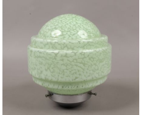 An Art Deco chrome and mottled green glass light shade.