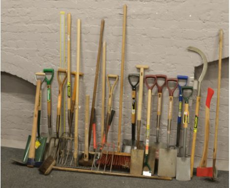 A large collection of garden hand tools; spades, shovels, lopers, brushes and woodmans axe etc.
