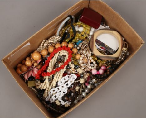 A box of costume jewellery including beads, bangle, necklaces, brooches etc.