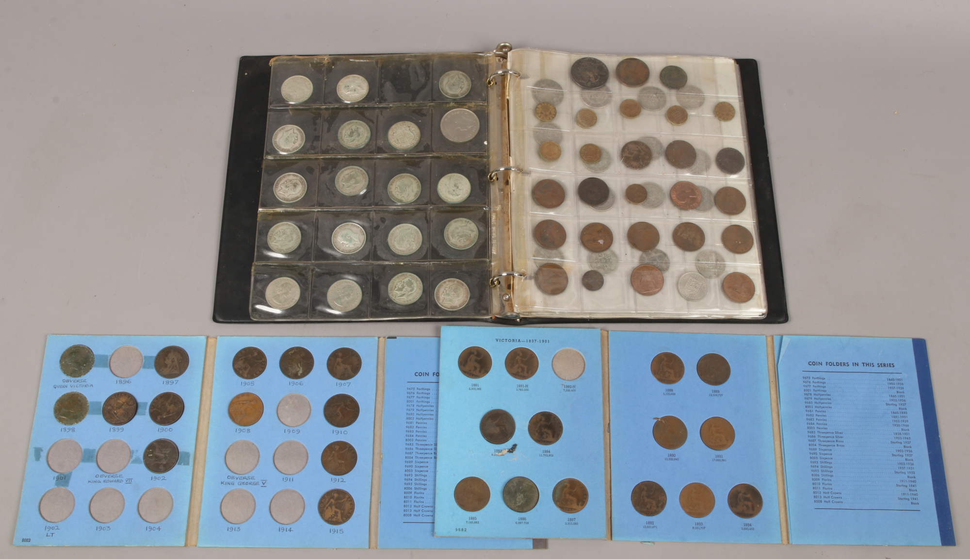 A folder of pre decimal British coins including some silver examples