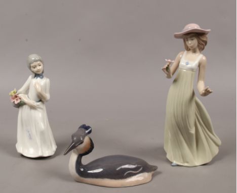 A Royal Copenhagen model of a duck, a Nao figure of a girl (missing one finger) and a similar figure of a girl.