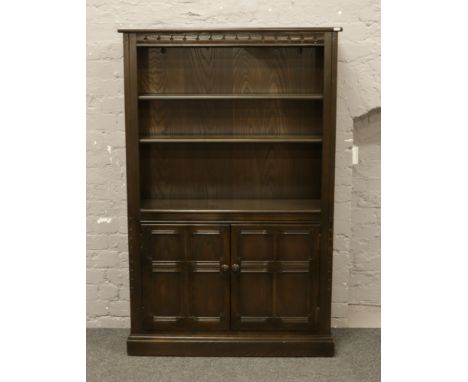 A black Ercol bookcase over cupboard base.