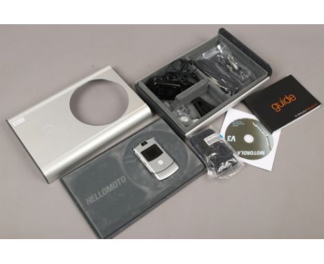 A Titanium Motorola mobile phone in box with accessories.