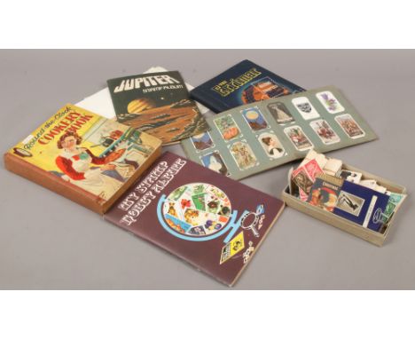 Two vintage stamp albums, loose stamps, cigarette cards and a round the clock cookery book.