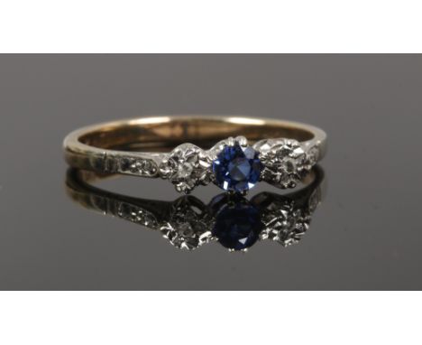 An 9ct gold and platinum sapphire and diamond three stone ring, size R.