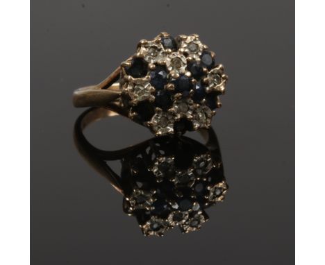 A 9ct gold diamond and sapphire cluster ring, size K.