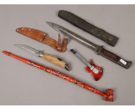 A World War II bayonet and sheath along with a vintage hunting knife with deer foot handle in sheath and an Indian smoking pi