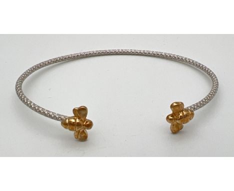 A boxed 925 silver cuff style bangle with bee design finials. Honeycomb design to body of bangle with a gold overlay bee to e