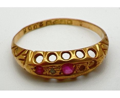A vintage 18ct gold ruby and diamond gypsy style ring with scroll decoration to shoulders. One small diamond missing. Full ha