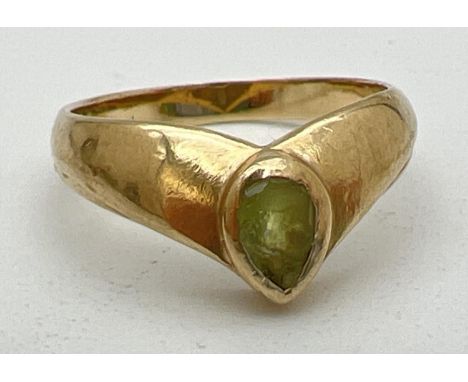 A 9ct gold wishbone style yellow gold dress ring set with a teardrop cut peridot (wear to stone). Full hallmarks to inside of