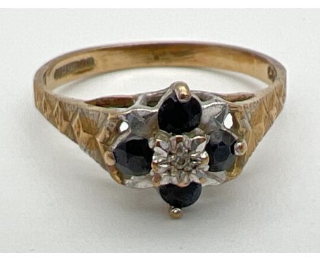 A vintage 9ct gold sapphire and diamond dress ring. A small central round cut diamond surrounded by 4 round cut sapphires (2 