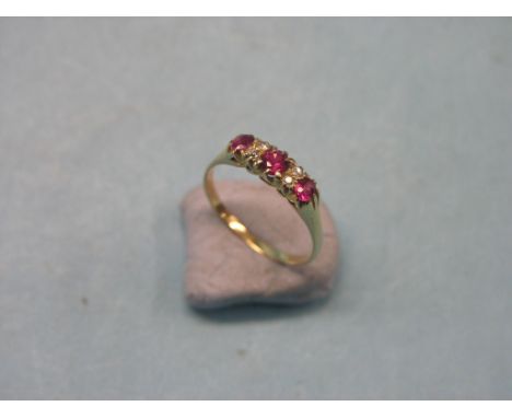 An 18ct. gold, diamond and ruby half-hoop ring, four diamond chips, three rubies, claw settings, size R