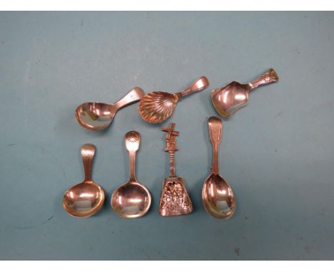 A group of six silver caddy spoons, Georgian and later, and a Dutch embossed white metal caddy spoon with novelty windmill fi