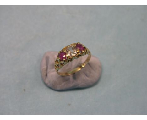 A gold, ruby and diamond half-hoop ring, central, old-cut diamond, approx. 0.7ct., two oval-cut rubies, claw settings, size Q