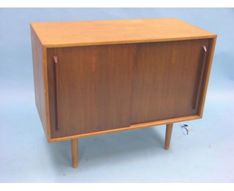 A mid 1950's teak cupboard designed by Robin Day for Hille of London, pair of sliding doors enclosing four sliding trays and 