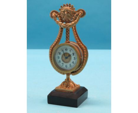 A gilt-metal lyre mantel clock, with enamelled dial, on square slate plinth, 8.5in.