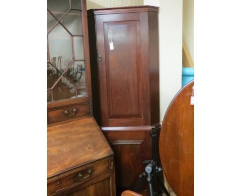 A solid mahogany standing corner cupboard, enclosed by two fielded panel doors, 7ft. 