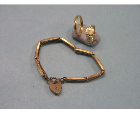 A 22ct. gold band wedding ring, 3.5 grams, a 9ct. gold signet ring, 1.9 grams, 9ct. gold gate-link bracelet, 9.6 grams