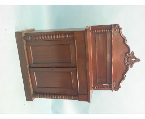 A Victorian mahogany chiffonier, raised panel-back with over-shelf and scroll cresting, serpentine-fronted cupboard base with