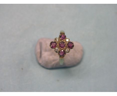 A 9ct. gold, ruby and diamond cluster ring, five round-cut rubies, four brilliant-cut diamonds, cruciform arrangement, size U