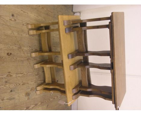 A solid, light oak nest of three tables, 2ft. 8in., and a similar dark oak nest of three tables 
