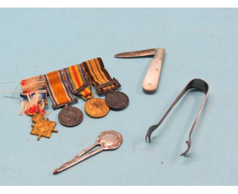 A small pearl-handled folding fruit knife, with silver blade, pair of silver sugar tongs, group of  four WWI miniature medals