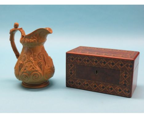 A Victorian parquetry tea caddy, with two enclosed canisters, 9in. together with an early Victorian relief-moulded stoneware 