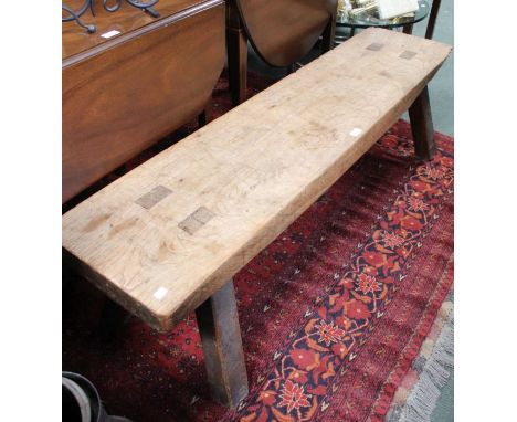 A probably 19th century elm topped pig bench of typical form &amp; construction, 153cm long