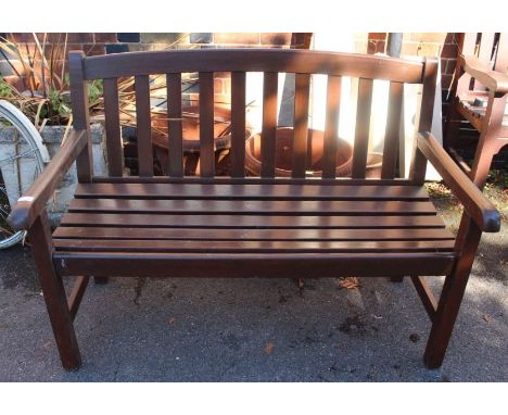 A garden bench of typical form and construction