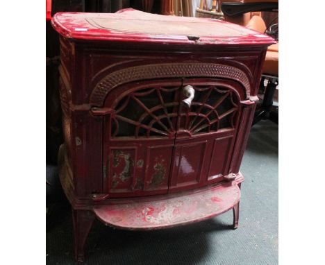 A cast iron red enamel log burner