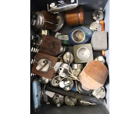 A crate of table lighters and lighter inserts