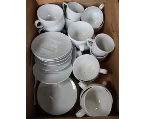 A box of Nespresso white cups and saucers
