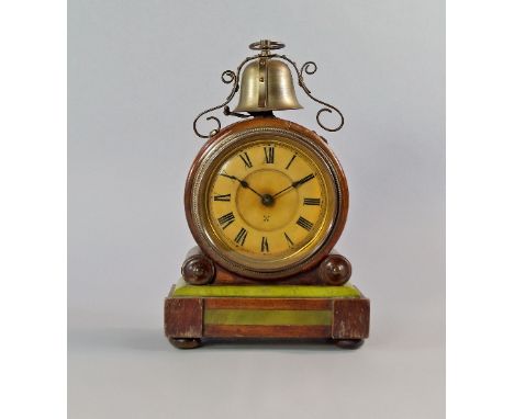 A German walnut circular cased mantel clock, late 19th/early 20th century, mounted with a striking bell, the case supported b