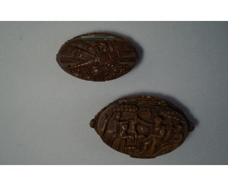 A French or German coquilla snuff box, 19th century, carved in relief with a scene of a hunter selling rabbits, 10cm wide, to