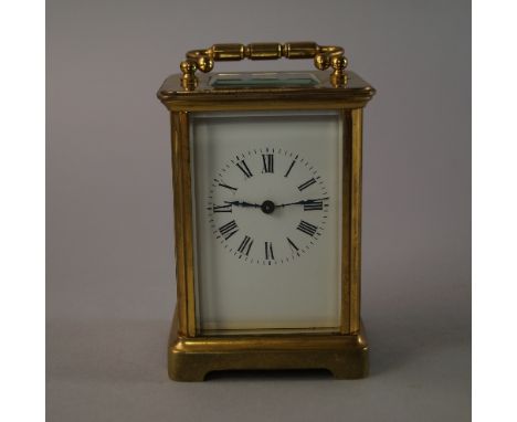 A French brass carriage time piece, 20th century, of rectangular form, the white enamel dial with Roman numeral chapter ring,