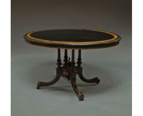 An Edwardian ebonised and walnut inlaid oval occasional table, on four column base, 76cm high x 130cm wide x 98cm deep.    