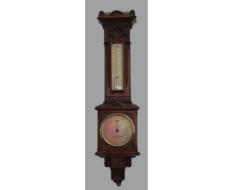 A Victorian Gothic revival oak barometer by Negretti and Zambra, late 19th century, the case carved overall with Gothic motif