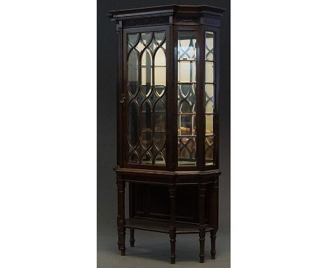 A mahogany display cabinet, 20th century, by repute Warring and Gillow,   the upper tier with swag hung cresting, Gothic glaz