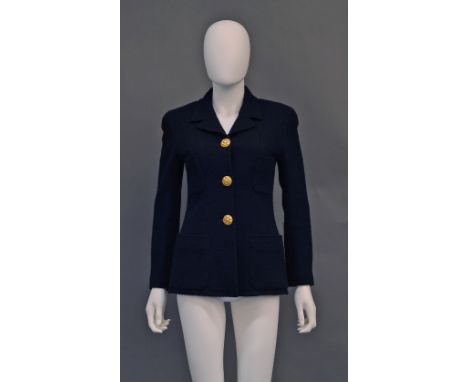 Chanel Boutique: A black wool bouclé fitted jacket, with three woven gilt metal buttons, stamped Chanel to verso and four fro