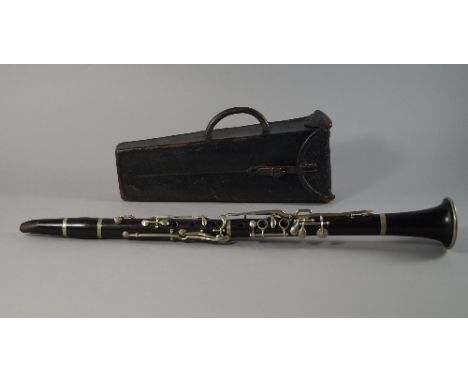 A Boosey and Hawkes clarinet, approximately 70cm long, in a padded case with accessories