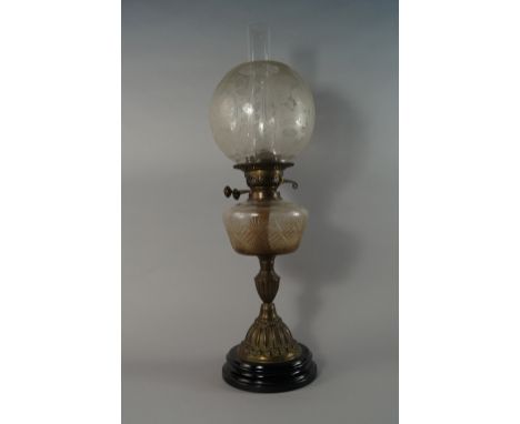 A Victorian oil lamp, with globular floral etched shade, above cross hatch moulded reservoir, on fluted metal and black potte
