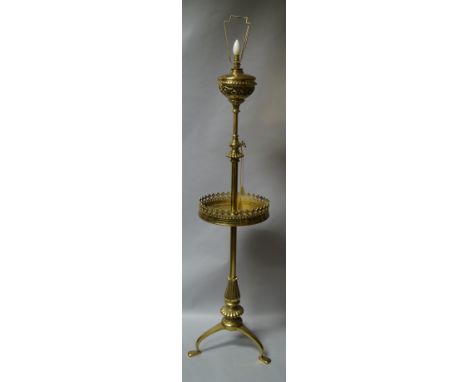 A late Victorian/early Edwardian brass oil lamp, with raising central column and pierced reservoir holder retaining the origi