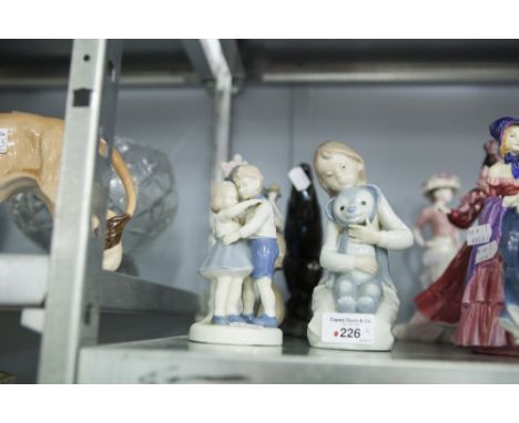 A NAO CHILD FIGURINE, ANOTHER, ALL SIMILAR (3) 