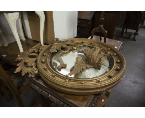 A LARGE GILT FRAME CONVEX WALL MIRROR, WITH EAGLE PEDIMENT (A.F.) AND A SMALL MAHOGANY TRIPOD WINE TABLE (2) 