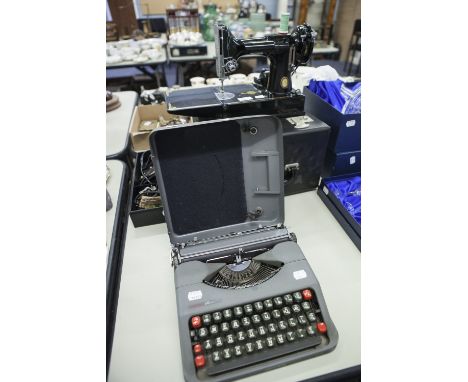 EMPIRE TYPEWRITER IN CASE AND A SINGER SEWING MACHINE IN BOX WITH ACCESSORIES (2) 