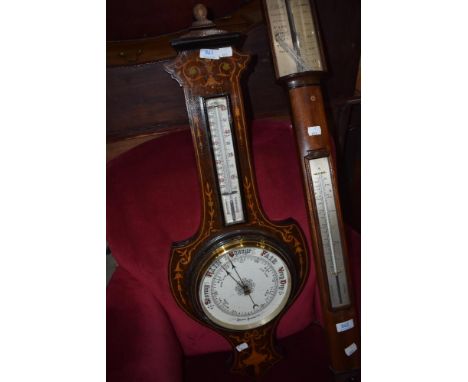 An Edwardian mahogany and inlaid barometer of shield form