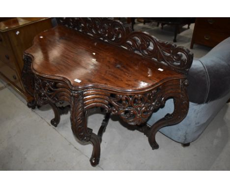 A 19th Century console/dressing table having foliate carved decoration